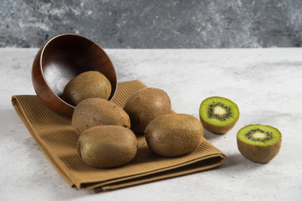 Freepik imagem: Muitos deliciosos kiwis em tigela de madeira.